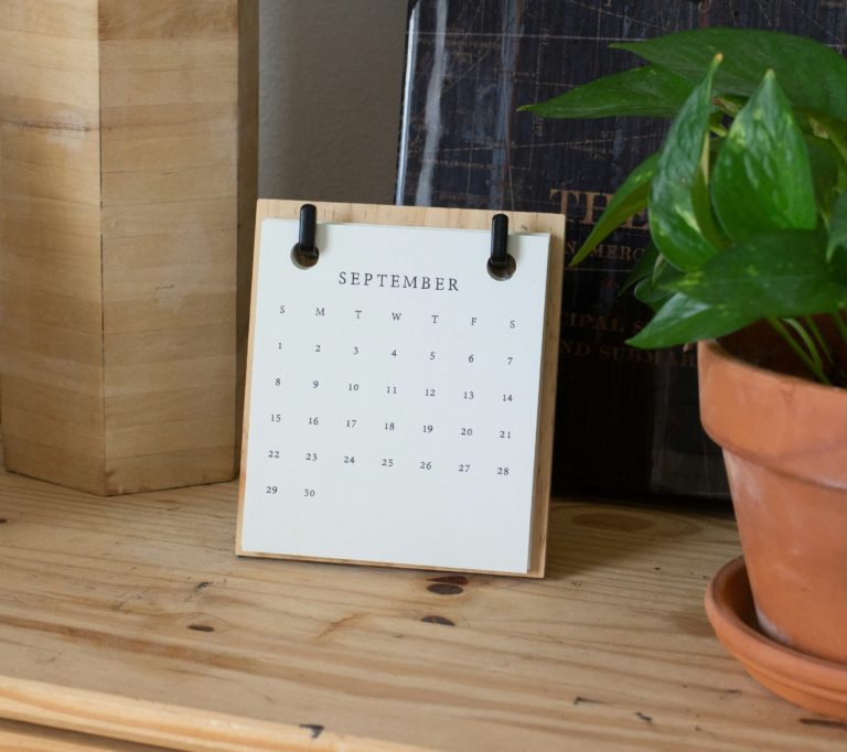 A calendar on a shelf